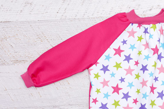 close up of pink sleeves on Stars art Smock