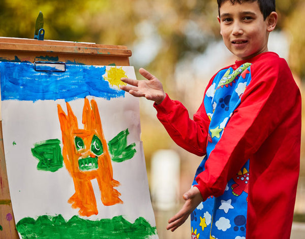 Boy wearing Red Dinosaur art smock