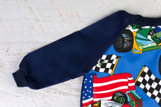 close up of navy sleeves on racing cars art smock